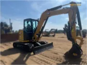2024 Caterpillar 305 CR mini excavator with compact radius, stick steer travel mode, and high-performance hydraulics for precision digging and utility work.